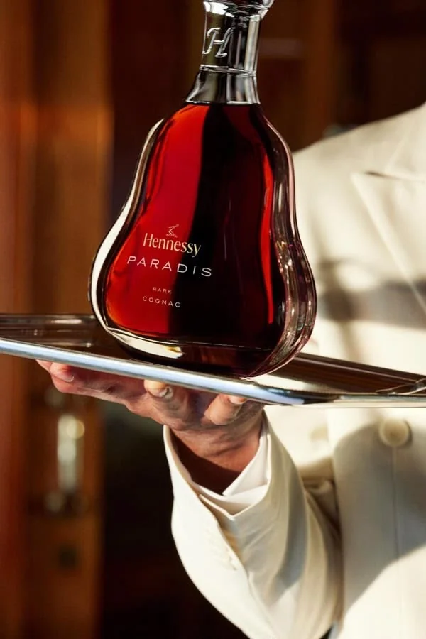 Hennessy Paradis carried on a silver tray by a waiter in a white jacket