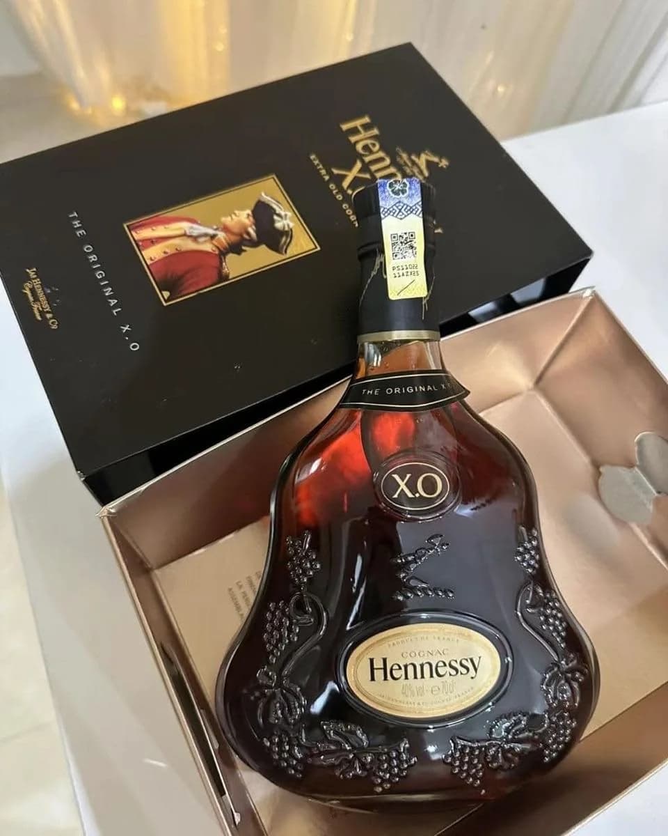 Hennessy X.O in its case, toned like an old print